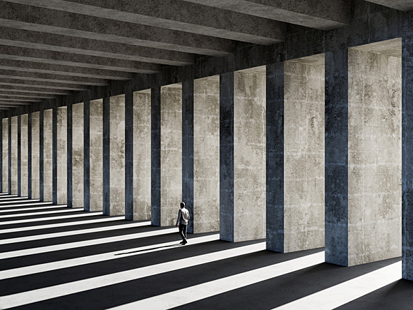 Man wlaking past concrete pillars